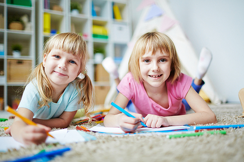 Portrait of two little sister drawing