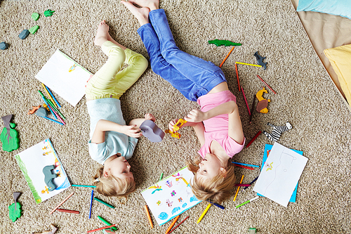 Cute girls playing with toys on the floor