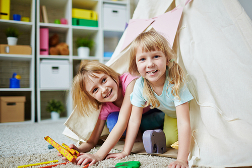 Happy little sisters  during play