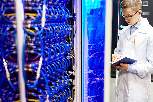 Young IT specialist inspecting work of super PC