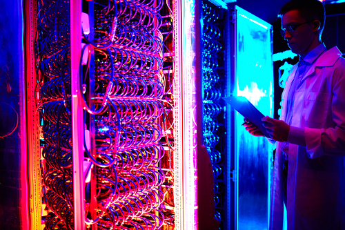 Young engineer working in data storage center