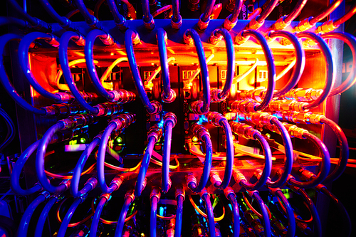 Supercomputer with row of cables in neon light