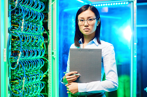 Portrait of a young woman scientist in supercomputer center