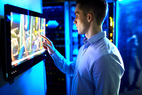 Man using touchscreen in university or museum