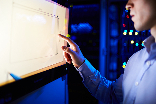 Businessman pointing at TV set