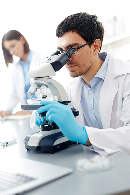 Male scientist studyin new substances in lab