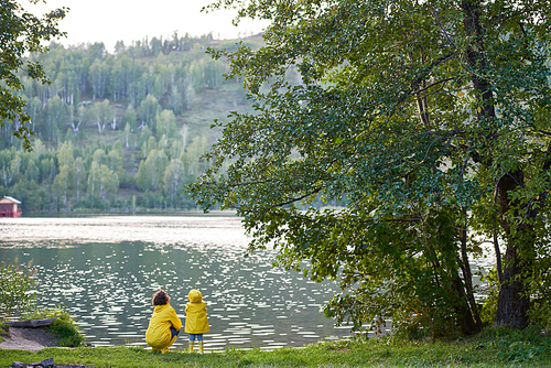 Parent and kid enjoying time by lake