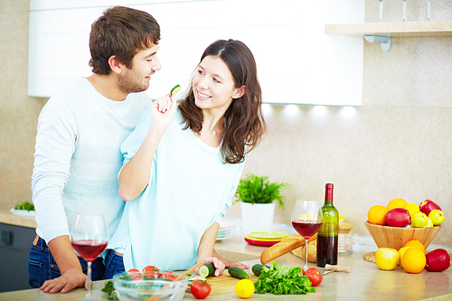 Young couple making salad together