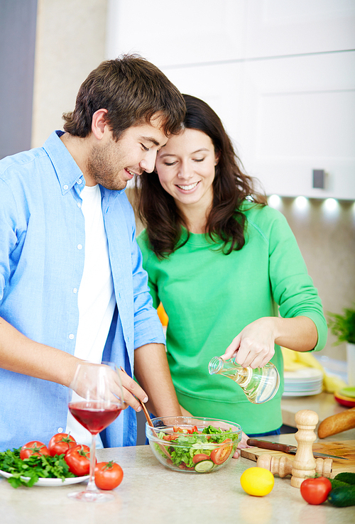 Young couple making healthy vegetarian salad