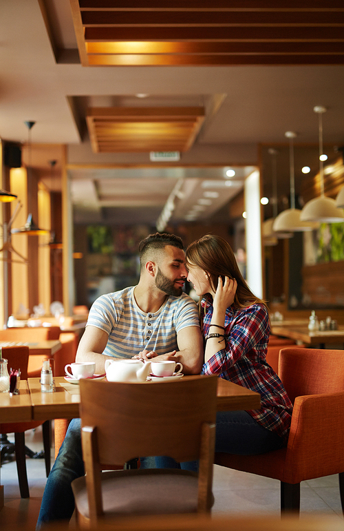 Amorous couple relaxing in cafe