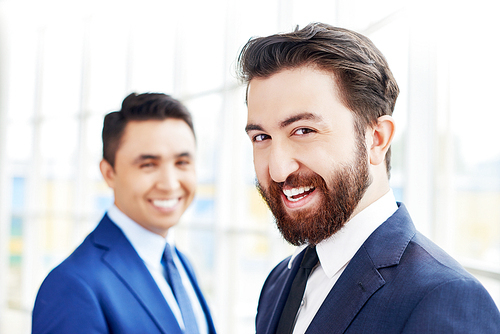 Portrait of two businessmen smiling at camera