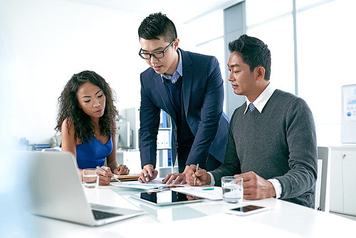 Vietnamese business team  working together in office