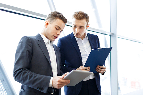 Young businessmen discussing sales level