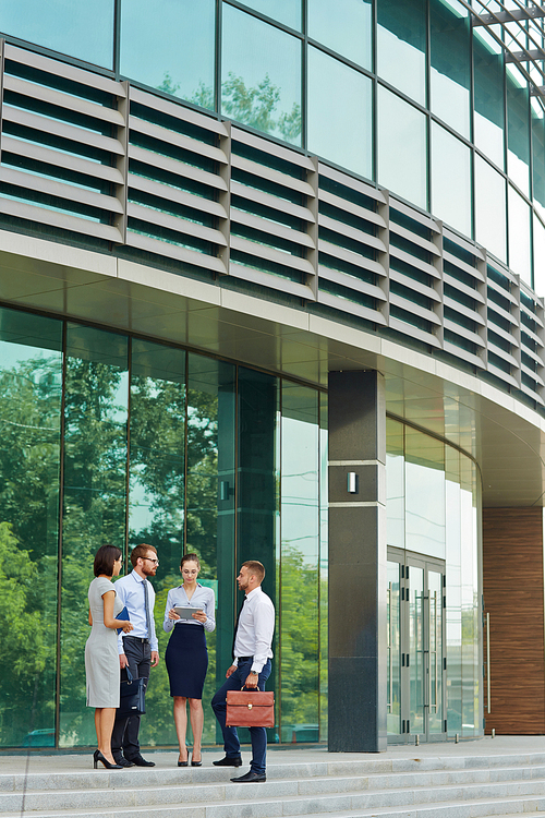 Business people standing near the modern building