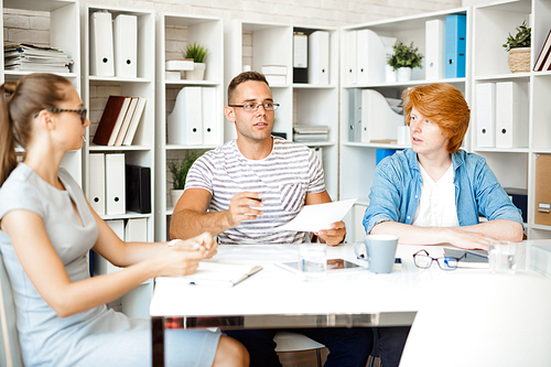 Group of creative people having conversation in office