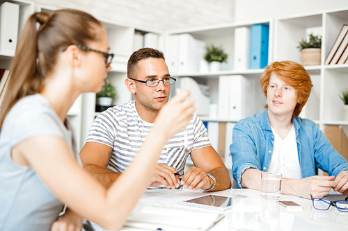 Modern creative designers discussing new project