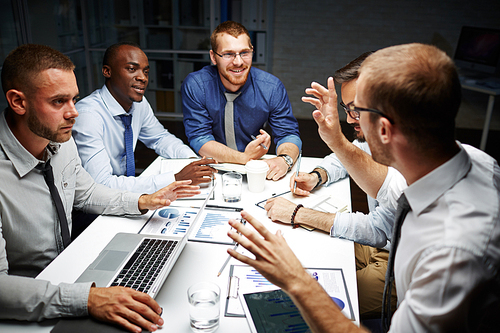 Group of brokers working late in office