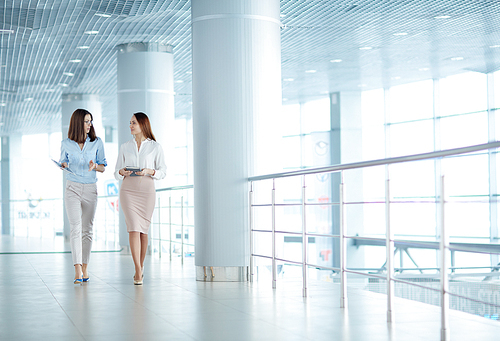 Two young businesswomen talking on business issues