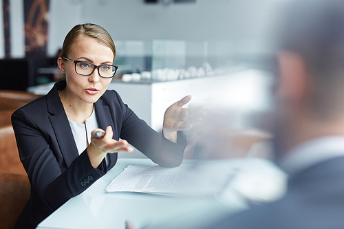 Confident manager explaining her idea to businessman