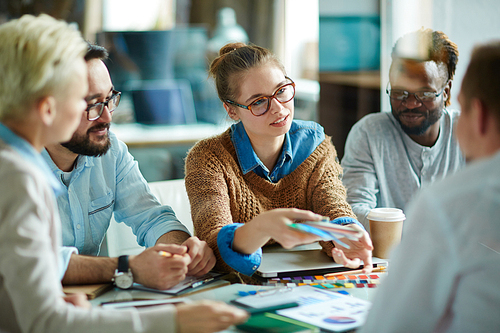 Group of multi-ethnic designers discussing colors of palette