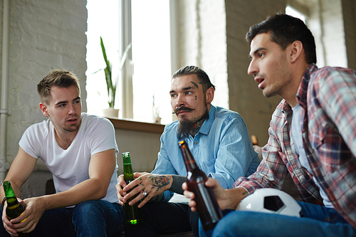 Tense guys watching tv broadcast of soccer championship
