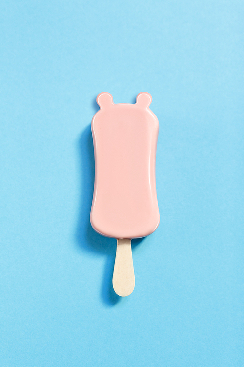 Pink ice-cream with ears over blue background