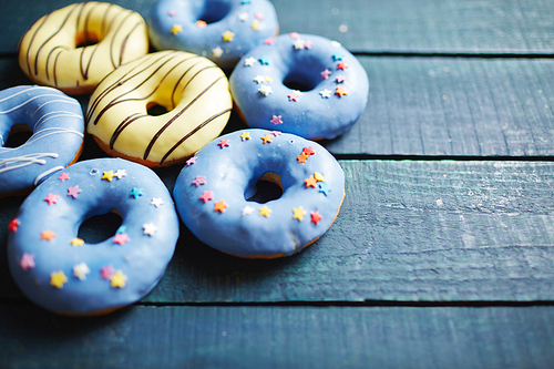 Close-up of sweet donuts on wooden table