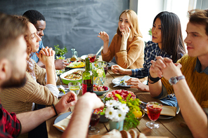 Group of intercultural friends having Thanksgiving dinner