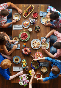 Group of young friends having festive dinner