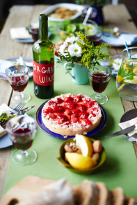 Strawberry cake, red wine and lemonade on served xmas table