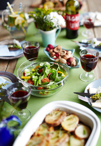 Bowl with vegetable salad on a rich dinner table