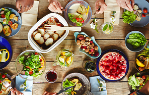 Human hands over festive table during dinner