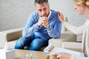 Female psychologist reassuring her patient during session