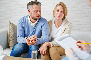 Married couple sharing their problems while visiting psychologist