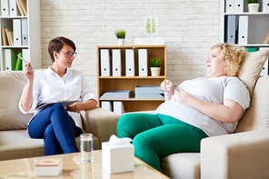Experienced psychologist talking to her patient with overweight