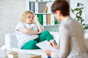 Young woman with overweight visiting psychologist
