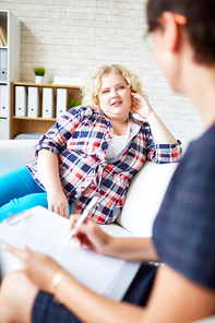 Young female with overweight listening to her psychologist