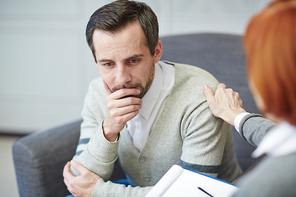 Confused or pensive man consulting with psychologist