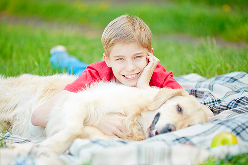 Portrait of happy teenage boy and his dog