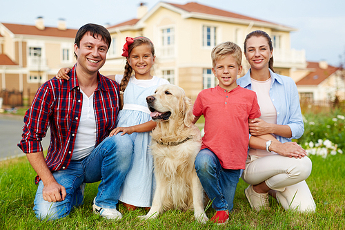 Happy family with dog  outdoors