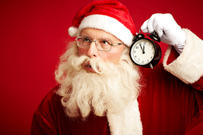 Santa wondering if his alarm-clock showing right time