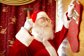 Santa Claus hanging Christmas stocking