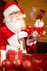 Santa preparing Christmas presents for women