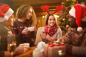 Young friends enjoying Christmas party at home