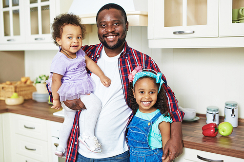 Portrait of happy father with his two daughters