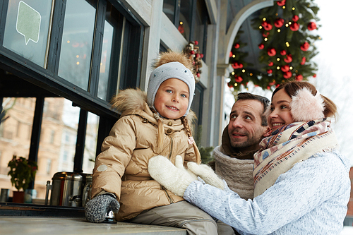 Young family having good time outdoors on xmas eve