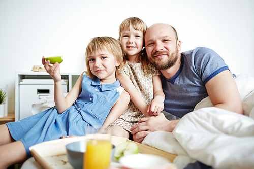 Happy family of father and two daughters 