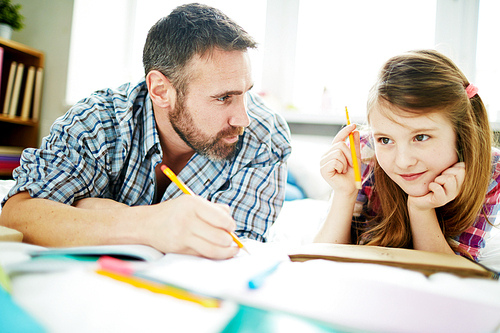 Man and his daughter thinking of what to draw