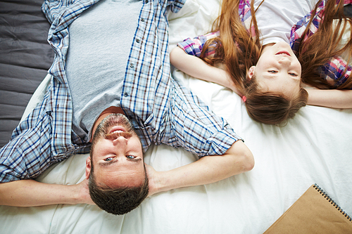 Relaxed man and his teenage daughter