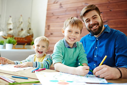 Father and sons drawing together